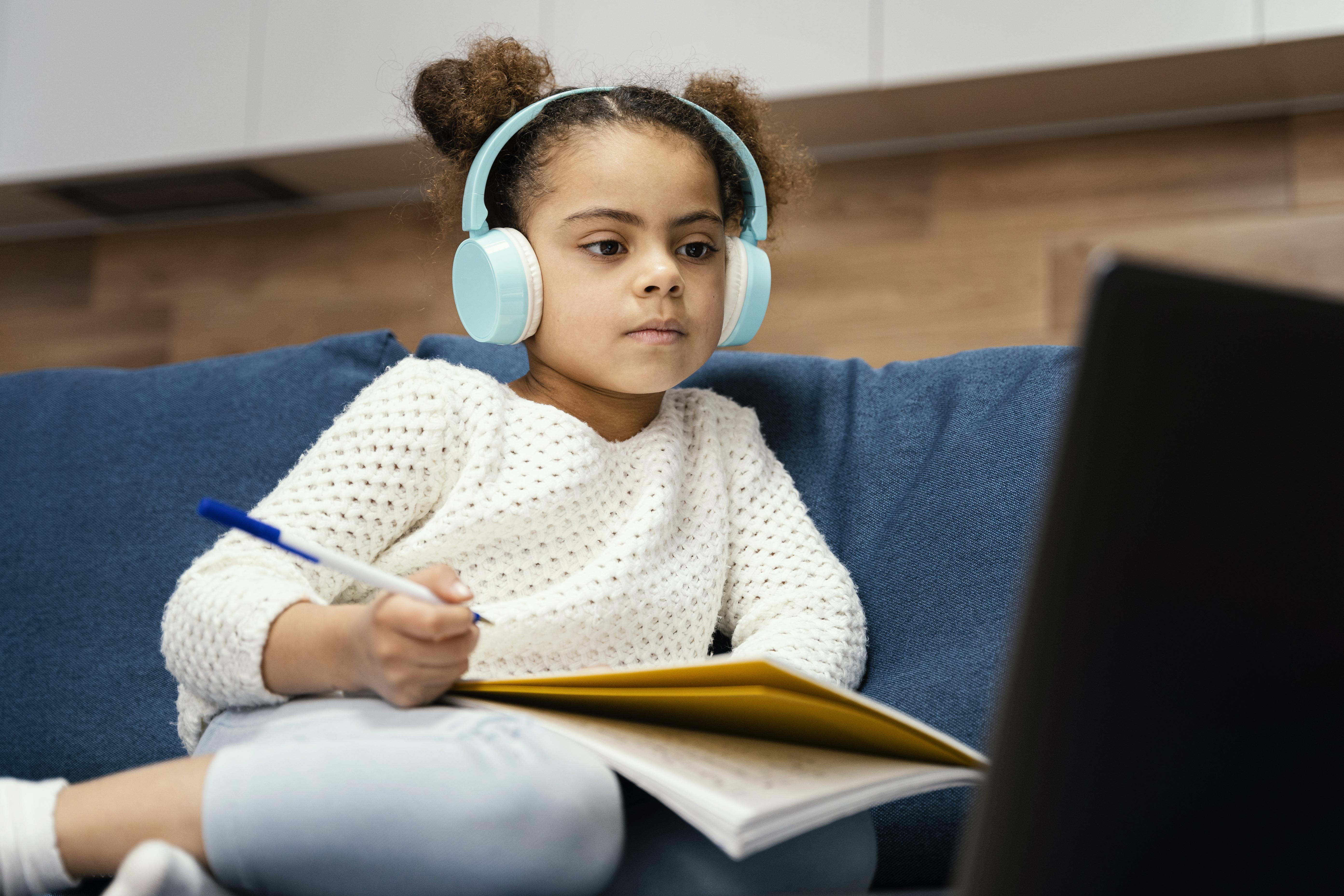 Child learning online with laptop and headphones